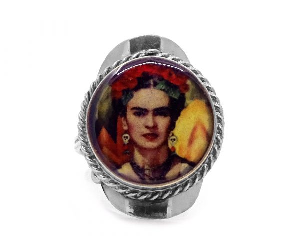Round-shaped acrylic Frida Kahlo face graphic design on alpaca silver metal ring with rope edge border in red, golden yellow, dark orange, beige, black, and olive green color combination.