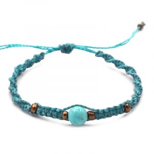 Macramé pull tie bracelet with turquoise howlite gemstone ball bead and seed bead centerpiece in turquoise blue color.