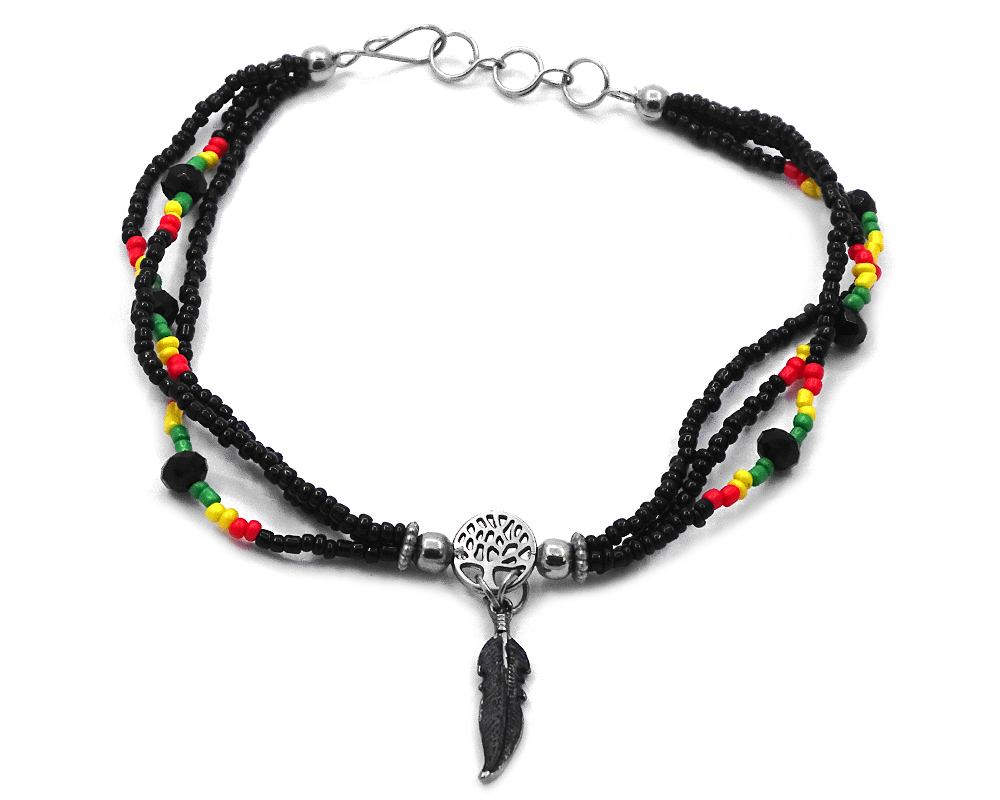 Seed bead and crystal bead multi strand anklet with silver metal tree of life charm and black metal feather charm dangle in Rasta colors.