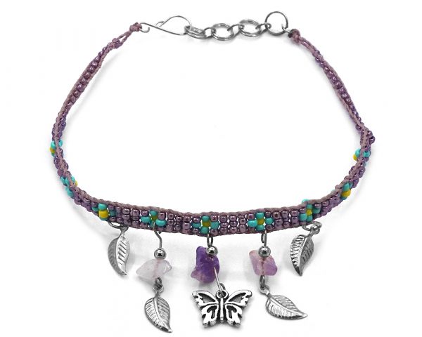Handmade floral seed bead strap anklet with chip stones, silver metal butterfly charm, and leaf charm dangles in purple, lavender, turquoise, and yellow color combination.