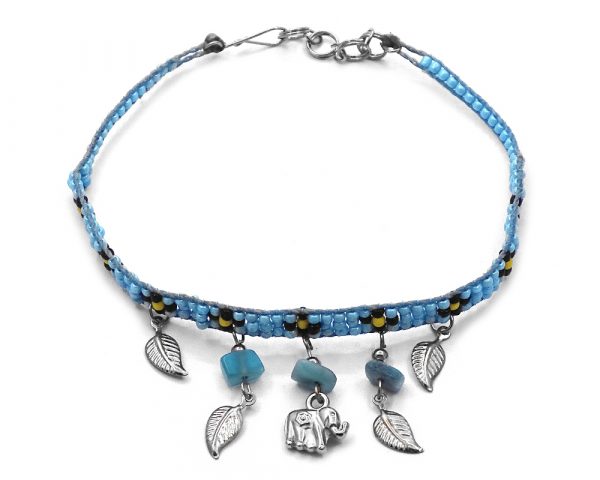 Handmade floral seed bead strap anklet with chip stones, silver metal elephant charm, and leaf charm dangles in light blue, black, and yellow color combination.