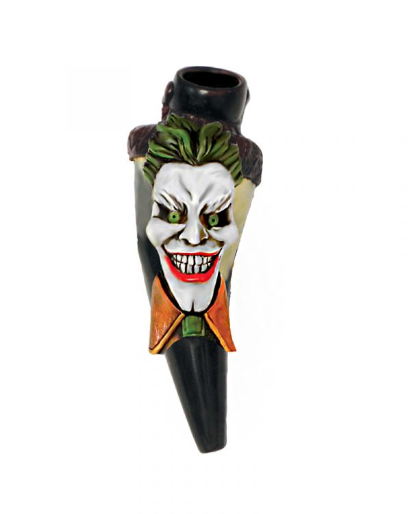 Handcrafted tobacco smoking natural bullhorn hand pipe of an evil clown character with a big head, creepy smile, green hair, and suit.