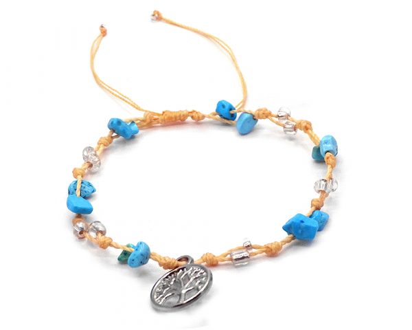 Handmade tied string pull tie anklet with chip stones, seed beads, and dangling silver metal tree of life charm in turquoise blue howlite, clear, and beige color combination.