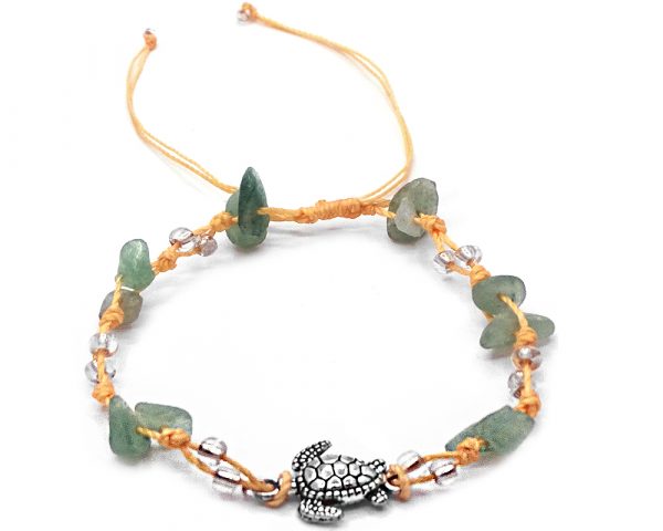 Handmade tied string pull tie anklet with chip stones, seed beads, and silver metal sea turtle charm in light green aventurine, clear, and beige color combination.