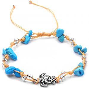 Handmade tied string pull tie anklet with chip stones, seed beads, and silver metal sea turtle charm in turquoise blue howlite, clear, and beige color combination.