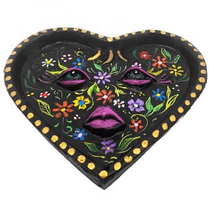 Handcrafted heart-shaped flat incense holder ash tray with image of a floral face in multicolored and black color combination.