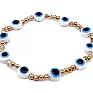 Handmade evil eye bead and seed bead stretchy bracelet in light blue, white, gold, and black color combination.