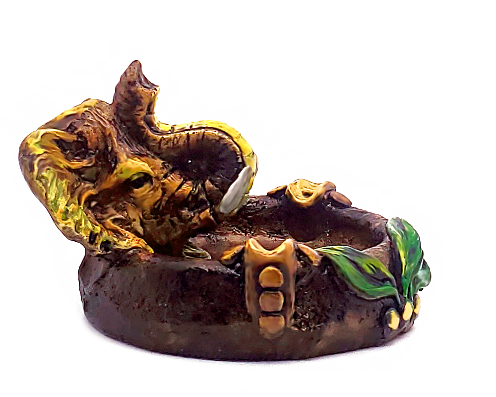 Handcrafted round incense holder ash tray with a leaf design and 3D figurine of an elephant head in yellow, beige, green, brown, black, and gold color combination.