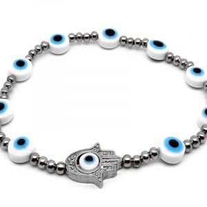 Handmade metal hamsa hand charm, evil eye bead, and seed bead stretchy bracelet in light blue, white, silver, and black color combination.