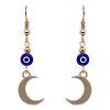 Handmade metal crescent moon charm dangle earrings with evil eye bead in blue, white, black, and gold color combination.