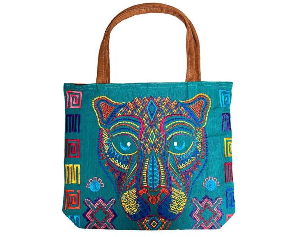 Handmade extra large tote purse bag with multicolored embroidered jaguar face and floral designs and brown vegan leather suede handle in assorted colors. Color will vary from examples in image.
