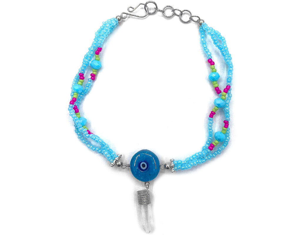 Handmade seed bead and crystal bead multi strand anklet with round-shaped clear acrylic resin and crushed chip stone inlay evil eye centerpiece and a clear quartz crystal point dangle in light blue turquoise, hot pink, lime green, blue, black and white color combination.