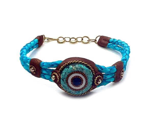 Braided dyed leather bracelet with brown resin, gold-colored metal, and round-shaped clear acrylic resin and crushed chip stone inlay evil eye centerpiece in turquoise blue color.