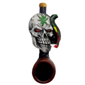 Handcrafted tobacco smoking hand pipe of a smoking Rasta skull with a leaf on forehead in mini size.