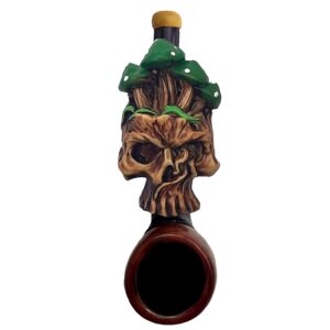 Handcrafted tobacco smoking hand pipe of a skull with green mushrooms in mini size.